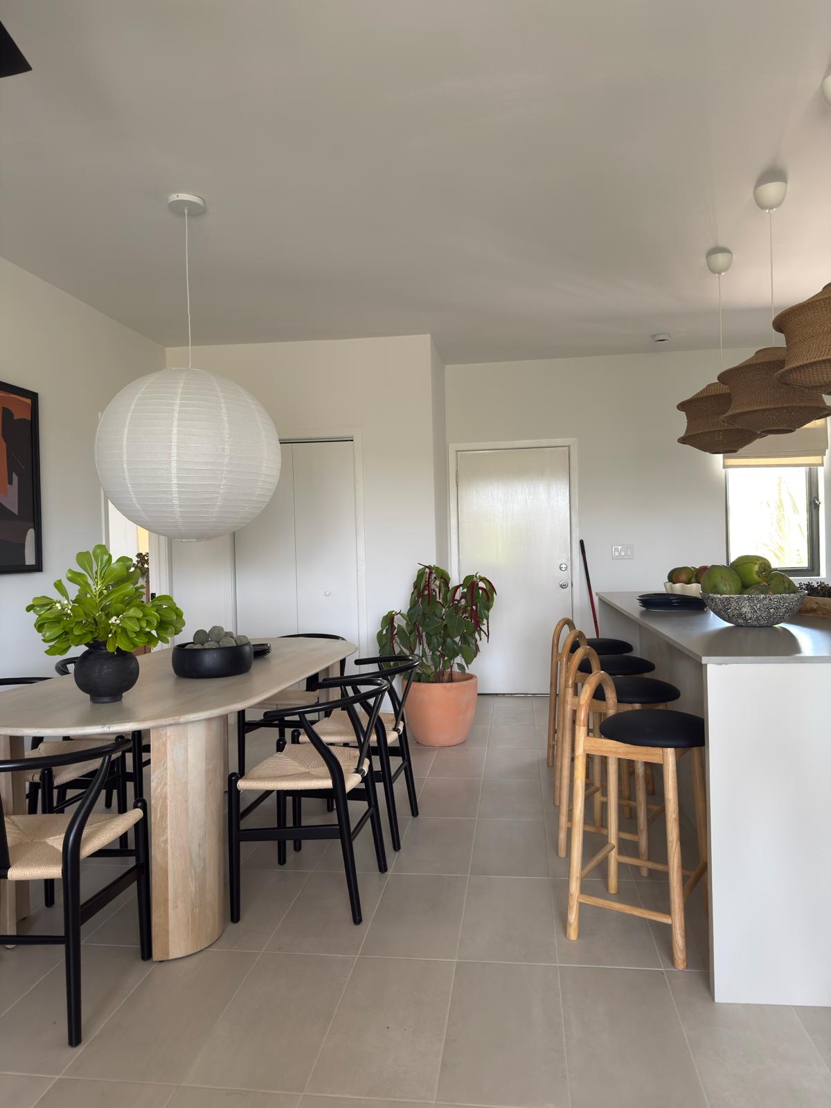 Modern apartment kitchen and dining area with neutral finishes